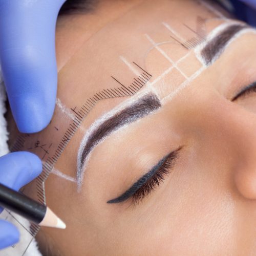 Permanent make-up for eyebrows of beautiful woman with thick brows in beauty salon. Permanent make-up for eyebrows of beautiful woman with thick brows in beauty salon.